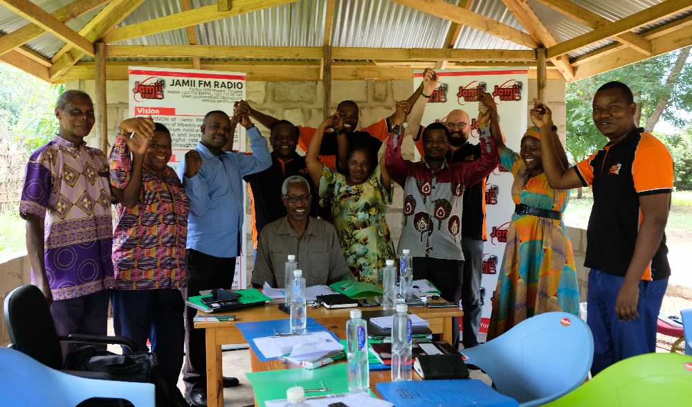 Iso joukko tansanialaisia radion kuuntelijoita tuulettaa iloisesti